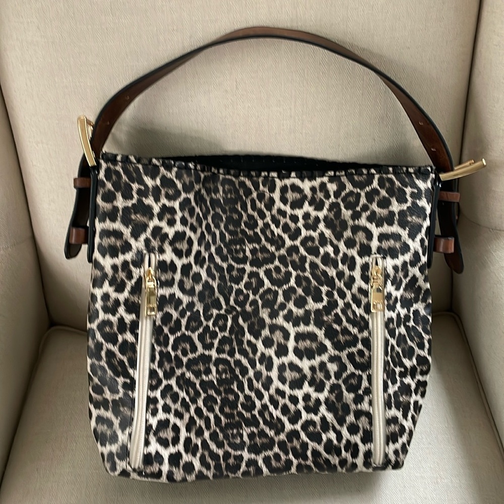Very good condition purse with cosmetic bad insert. Animal print